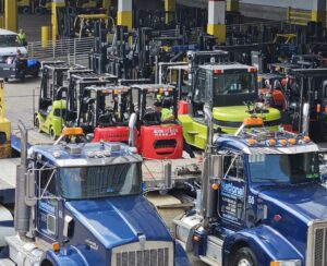 forklifts being delivered on trucks