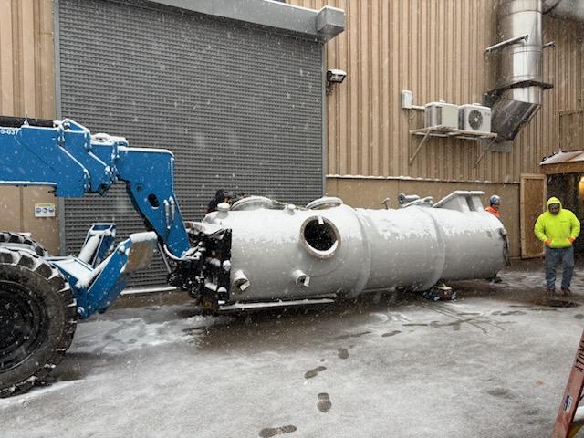 Genie telescopic forklift moving HVAC chamber section into commercial building
